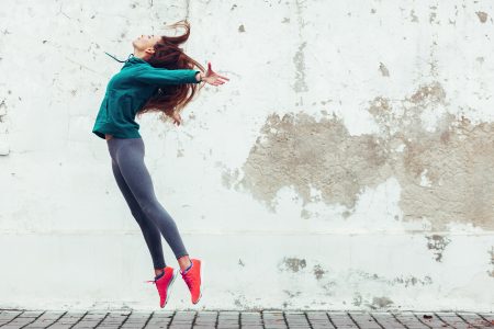 image of woman in fitness clothing jumping